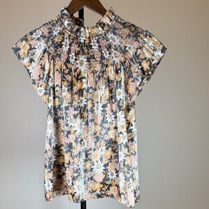 Moodie Floral Smocked Blouse in Black, Orange, and Cream. Size S